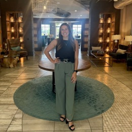 a woman standing in a large lobby lounge