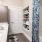 Cozy bathroom with shelves in the wall, large bathtub, and mirror