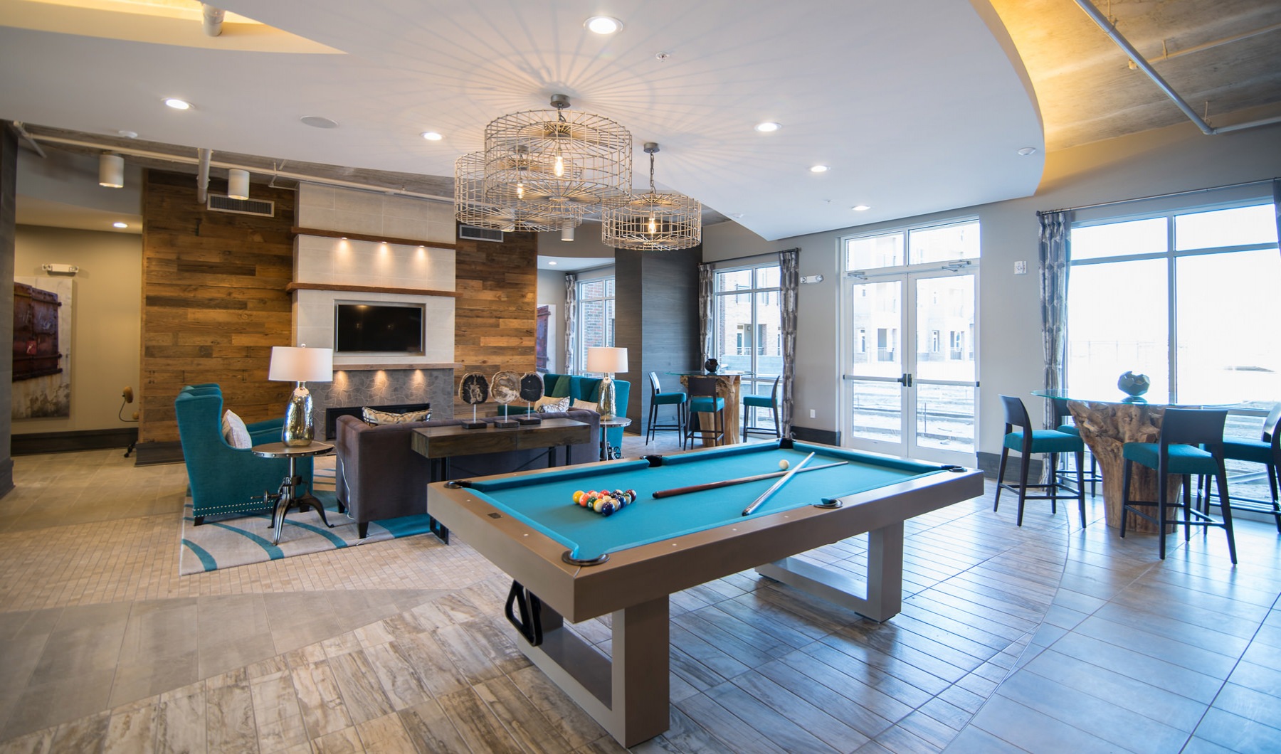 Open, resident lounge with billiards, comfortable seating, and lots of overhead lights